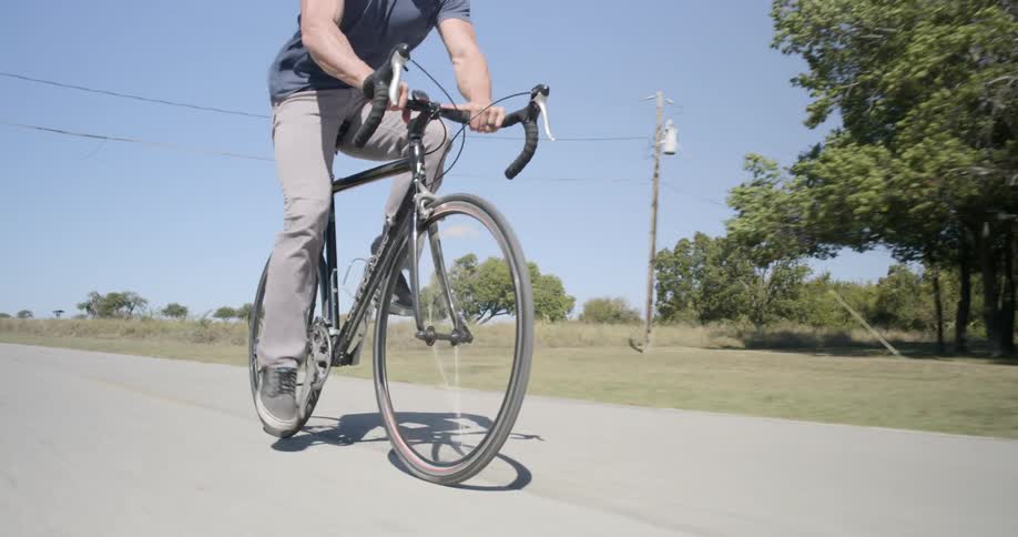A young man rides a bike outdoors