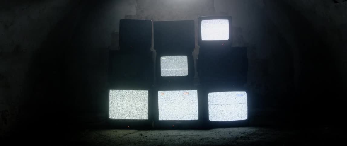 Televisions with fuzzy screens stacked together