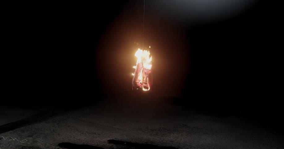A fire burning something in the dark
