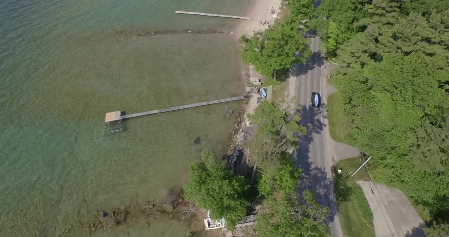 An aerial view of a car driving near beach