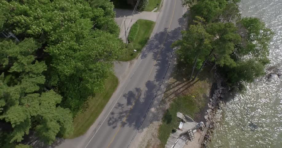 Birds eye view of the water shoreline and road