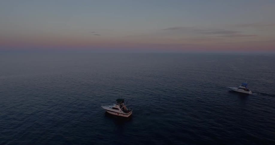 Boats heading out to sea during sunrise