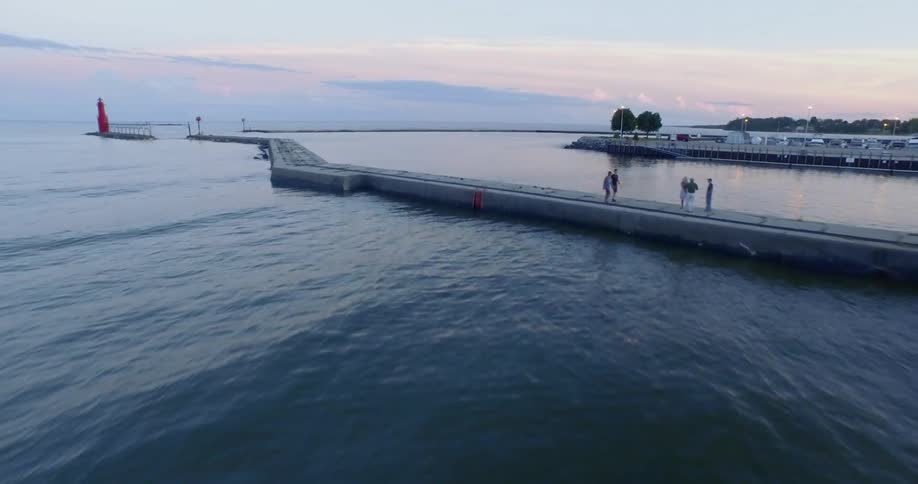 People walk along causeway dividing ocean and protected bay