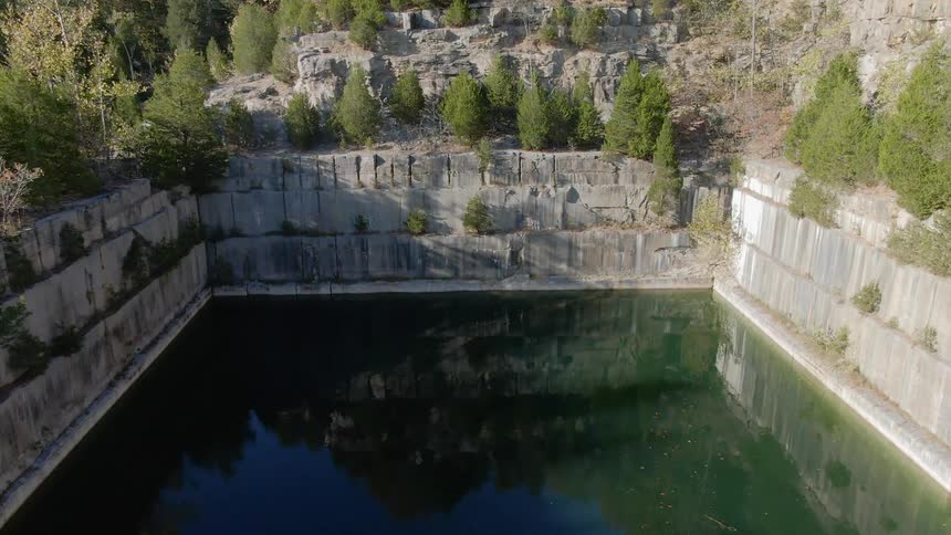 Stone walls surround a pool of water