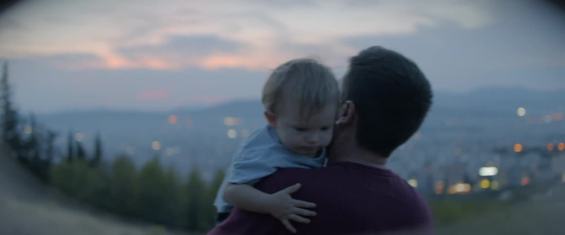 A child hugs a man