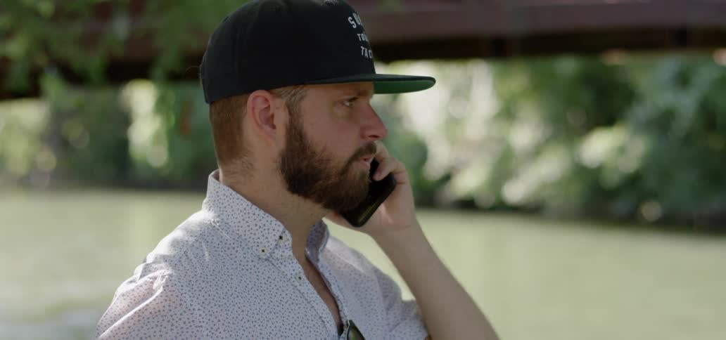 A man talks on a cell phone outside