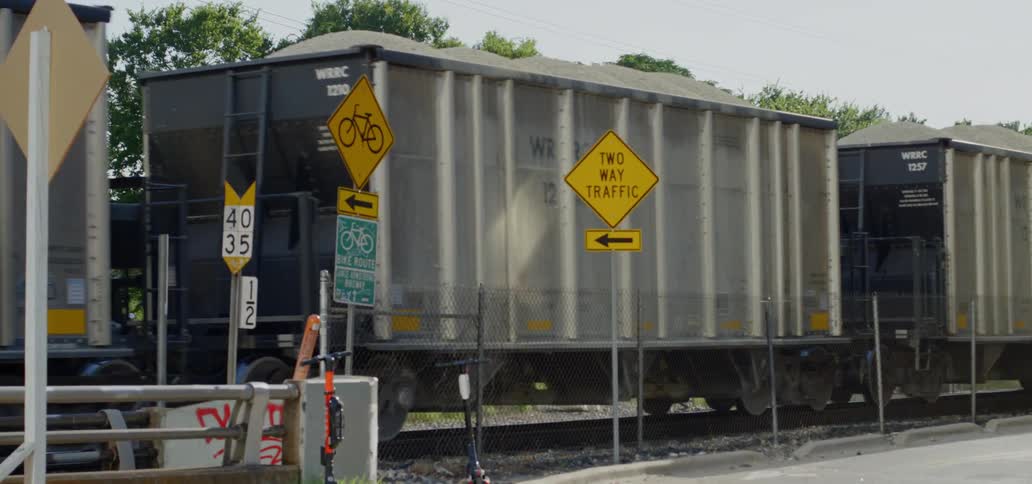 A train lumbers along a railroad track