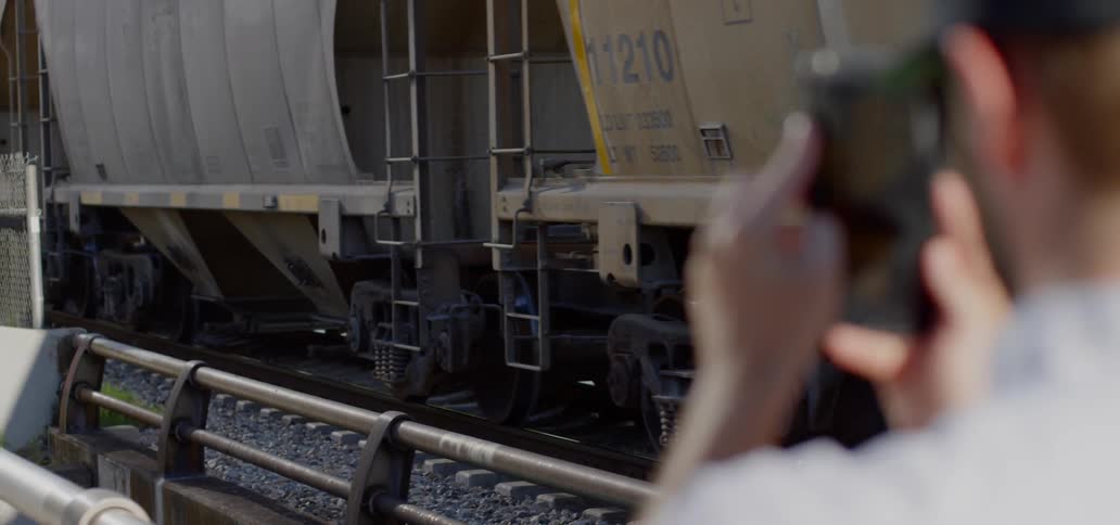 A person is recording a train go by