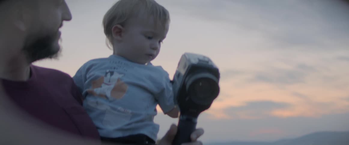 Father and son are playing outdoors together