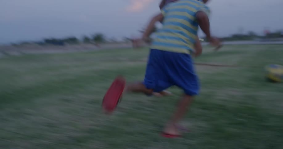 Latino children kicking a football on a pitch