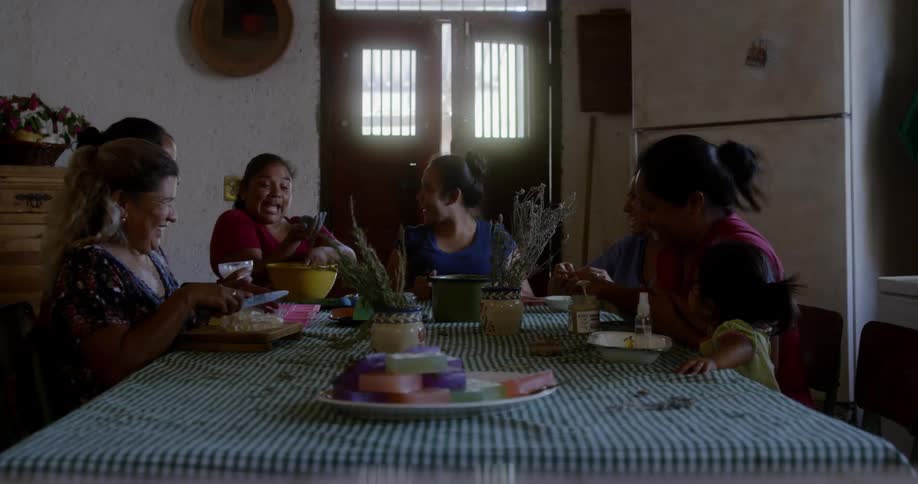 People are gathered around a table and eating dinner