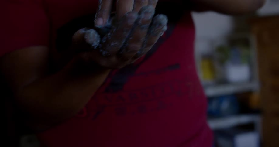 A woman removes a round object from a mold