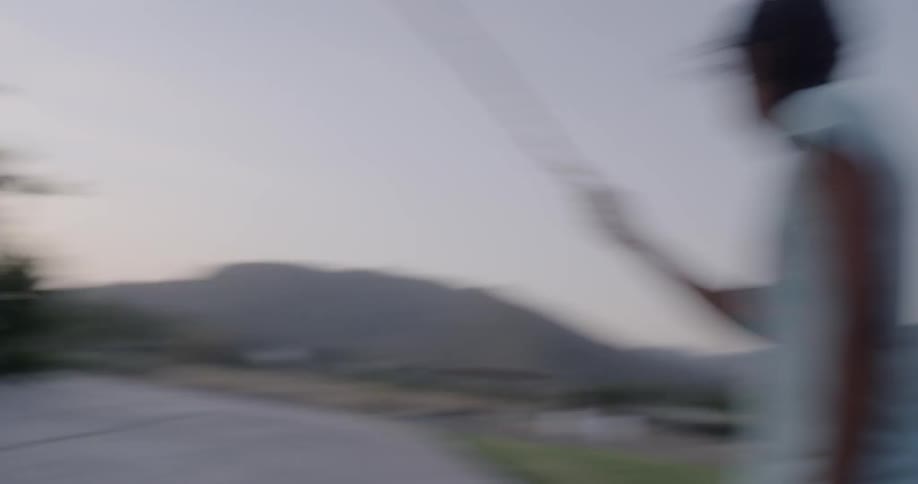 A group of children playing jump rope at dusk