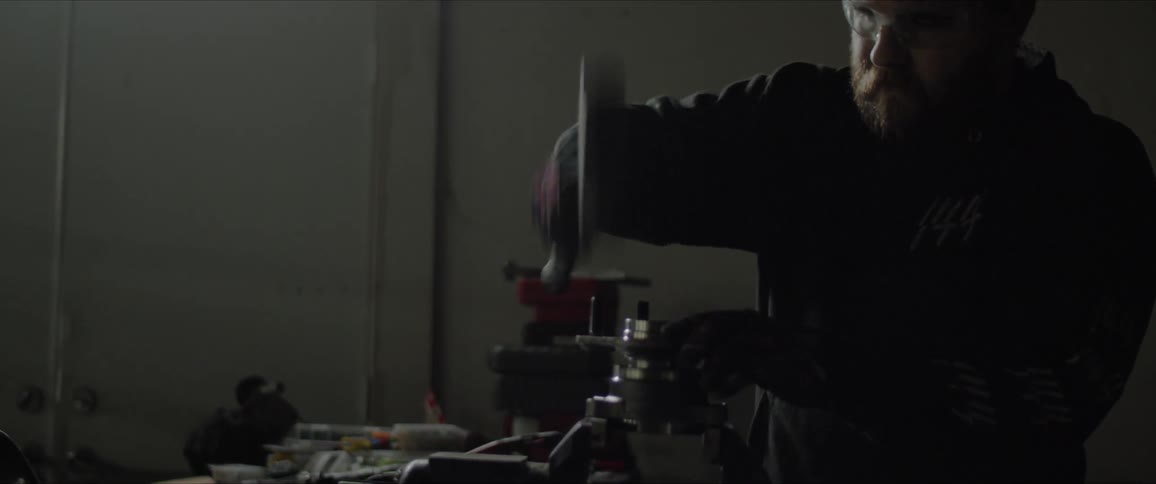 A man with safety glasses working at the factory