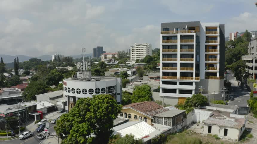A city is filled with a mix of single family homes and tall apartment buildings
