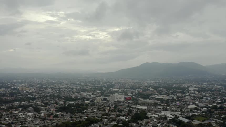 An aerial view of a city with mountain background