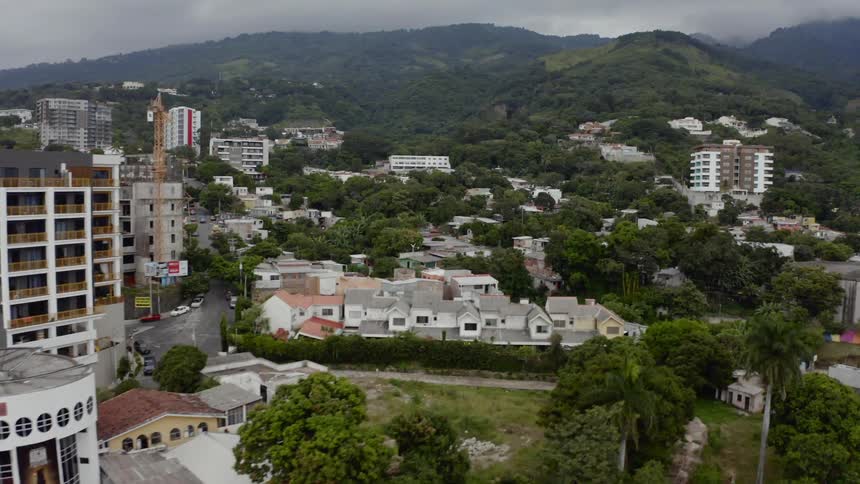 An urban area is nestled into a hilly area