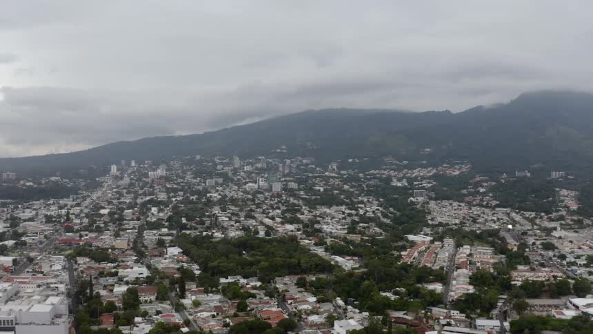 An aerial view of a city near a mountain range