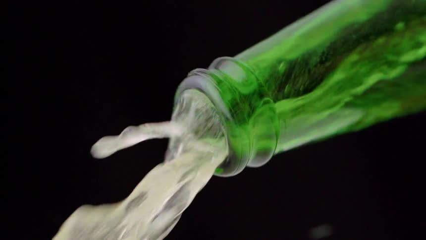 Liquid flowing from a green bottle