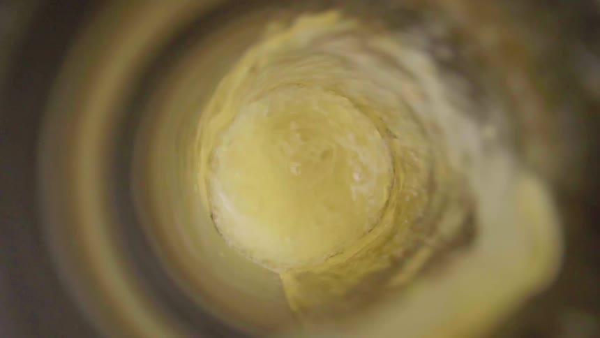 Beer pours into a glass spinning