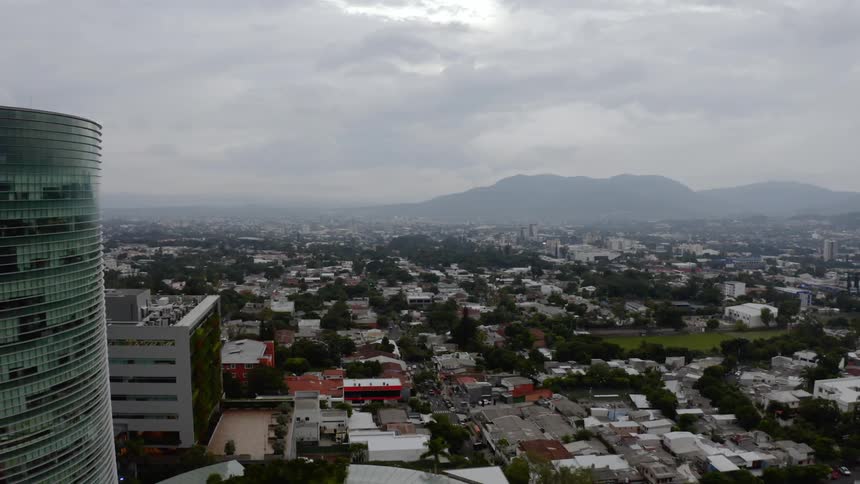 An aerial view of a neighborhood on a cloudy and foggy day