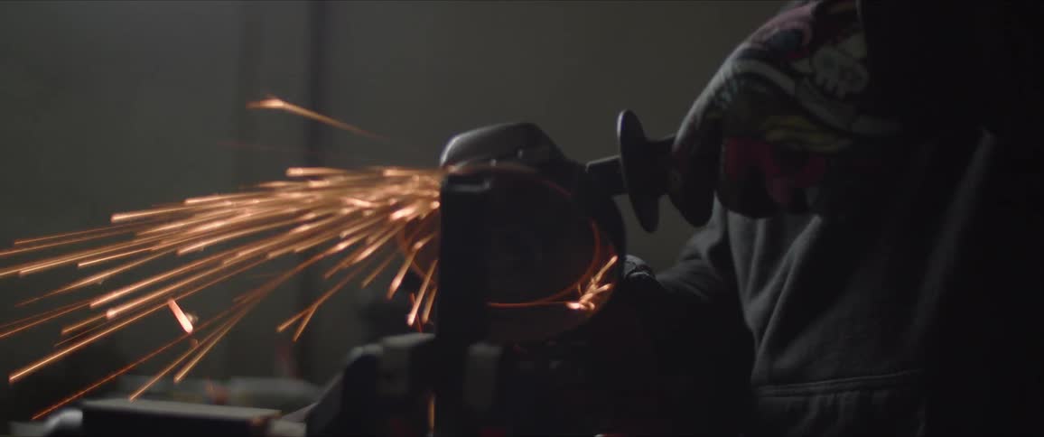 A factory working grinding on the steel