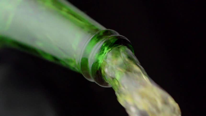 A green bottle pouring water