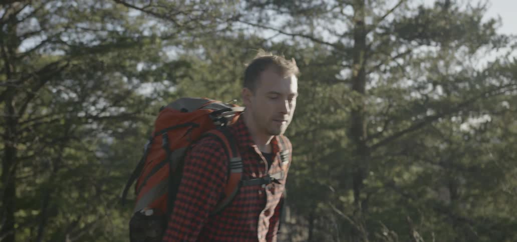 A man and woman hike in the wilderness together
