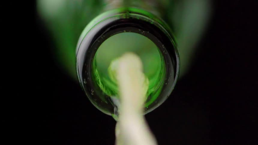 Beer bottle pouring water