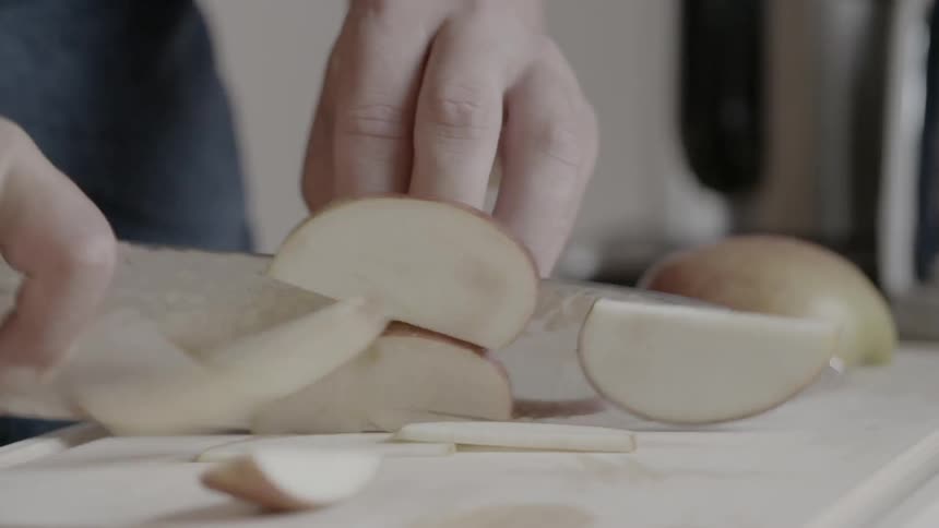 A person is chopping an apple