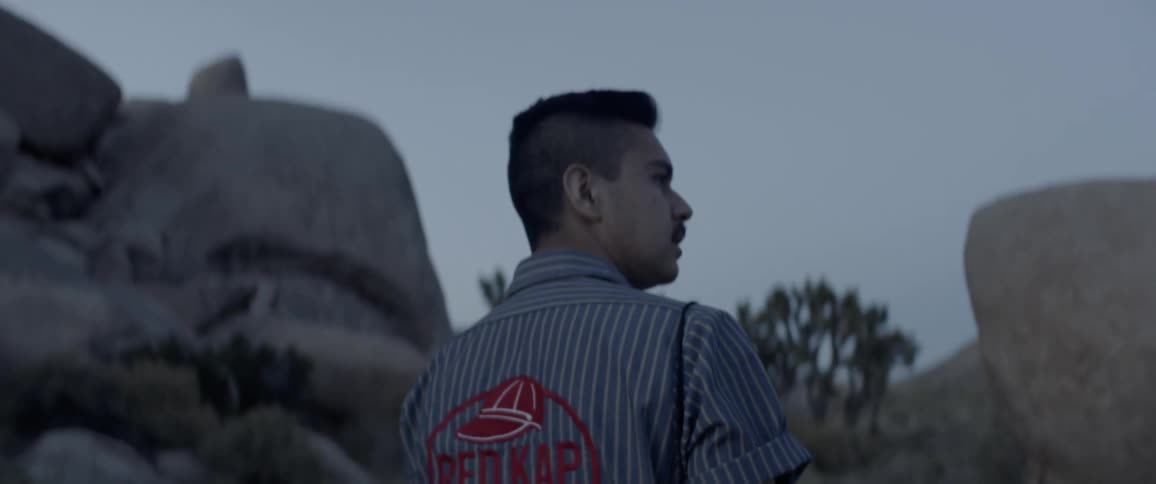 A man walks near rocks