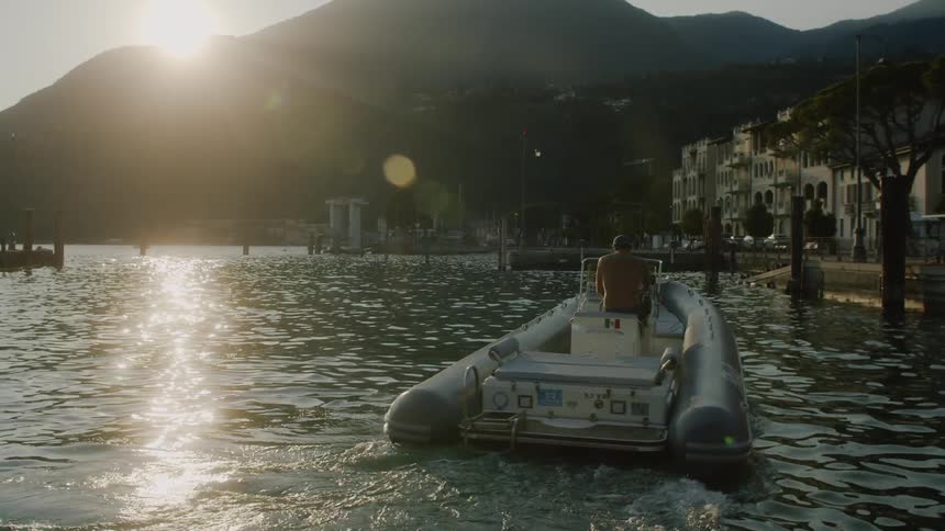 A man sails in the water on a rigid inflatable boat