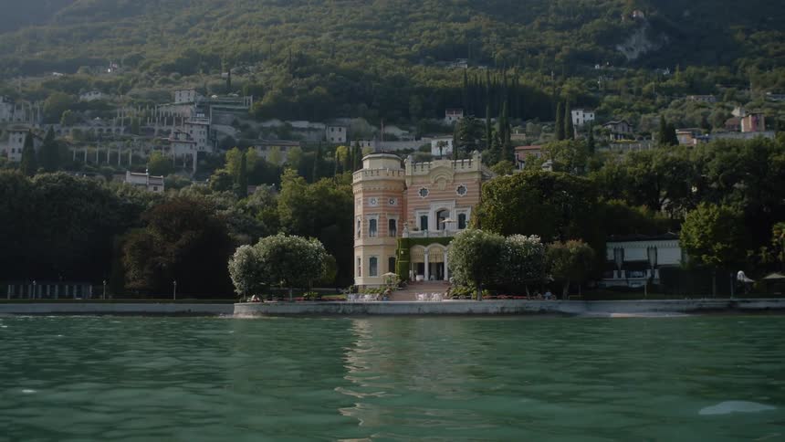 The water leads to a tall home near the shore