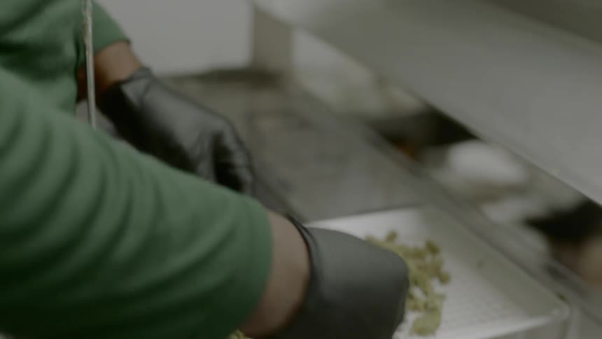 A man removes pieces off of the scale
