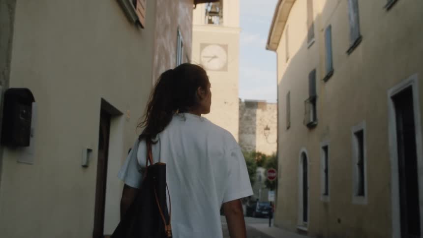A woman walking down the streets of a city