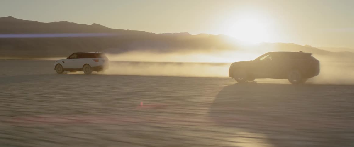 Vehicles driving fast in the desert at sunset