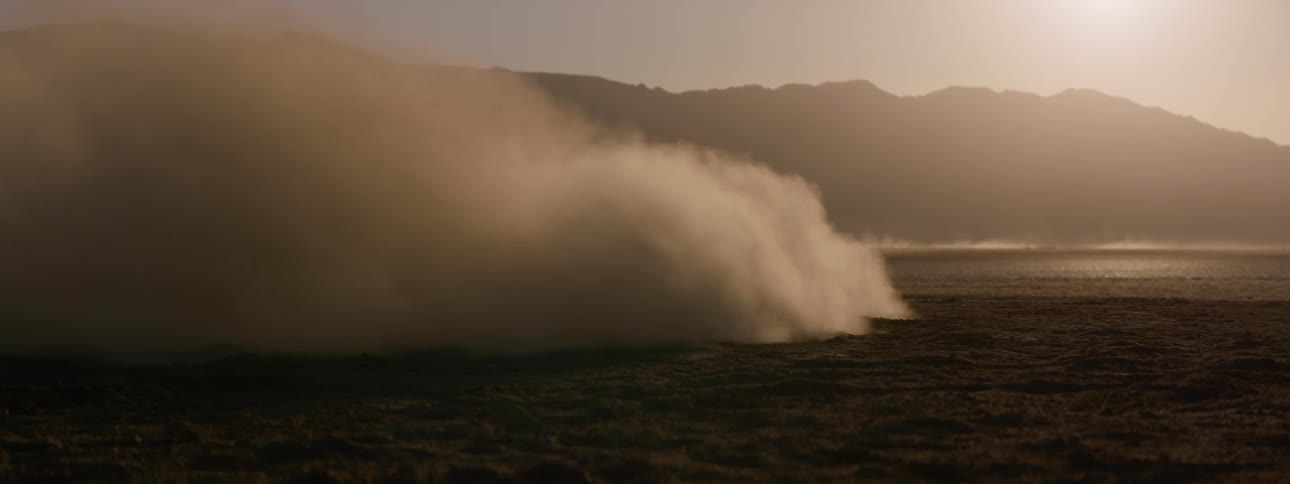 A black range rover sport driving across the salt flats
