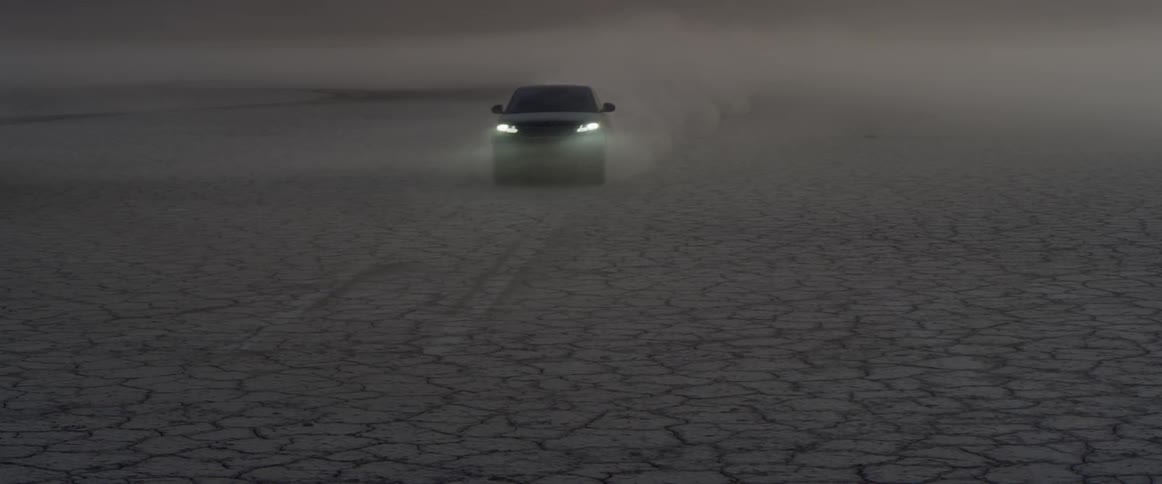 A black range rover sport driving across the salt flats