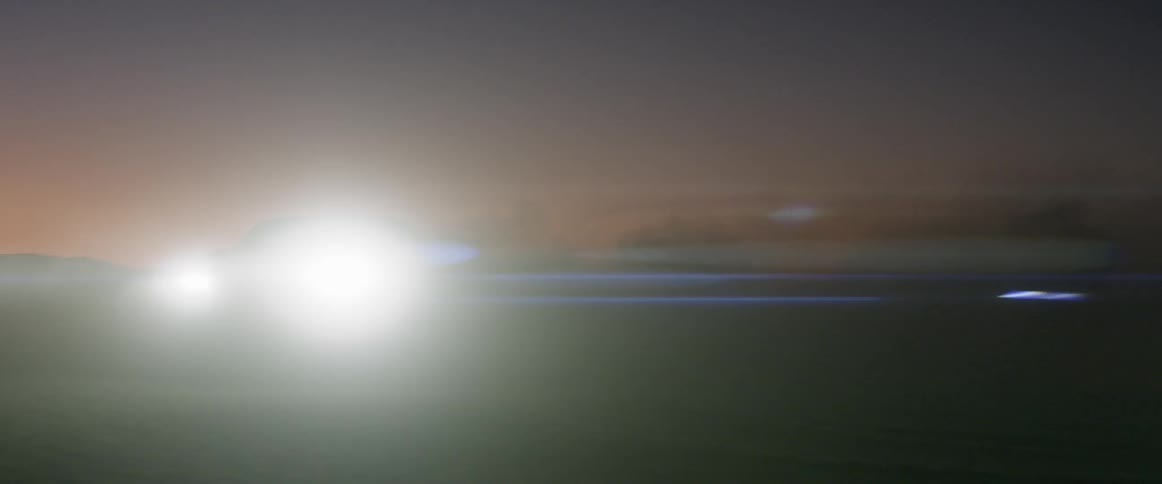 A black range rover sport driving across the salt flats