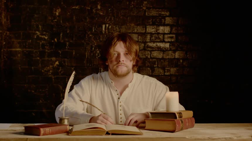 A man writing with feather pen in the room