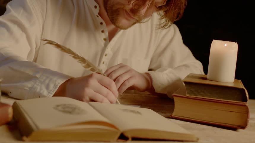 A man is writing in a journal
