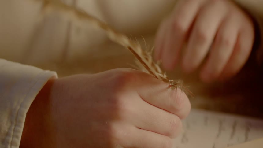 A man is writing in a journal
