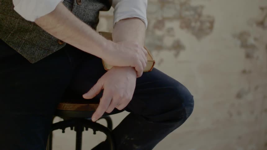 A person is sitting on the chair with a book