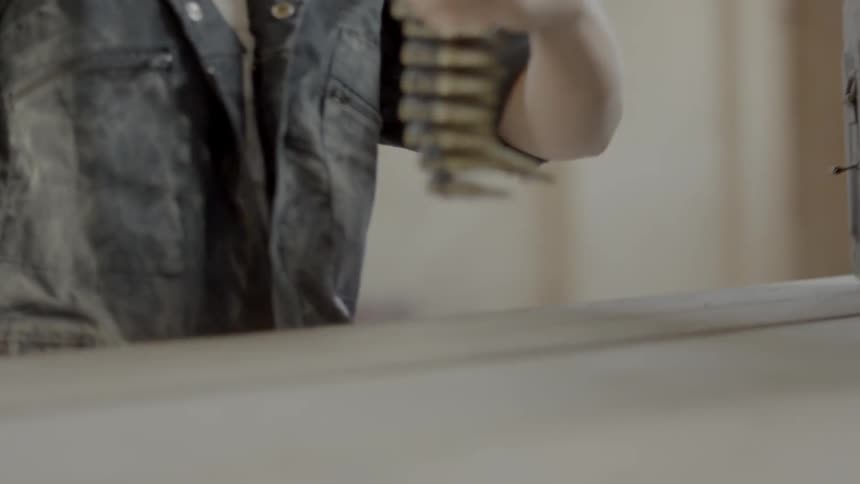 A woman taking a chain of bullets out of a tackle box