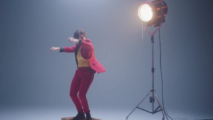 Woman dancing over wooden boxes inside a photo studio