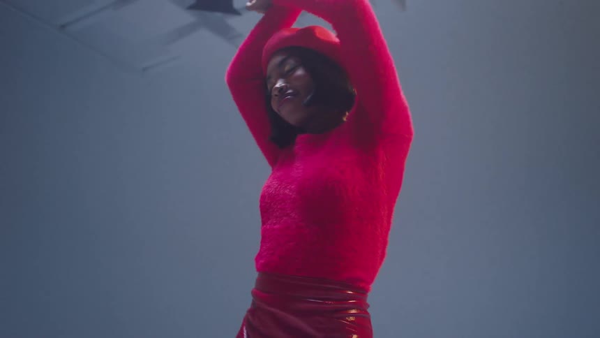 A young woman dances and poses for the cameras