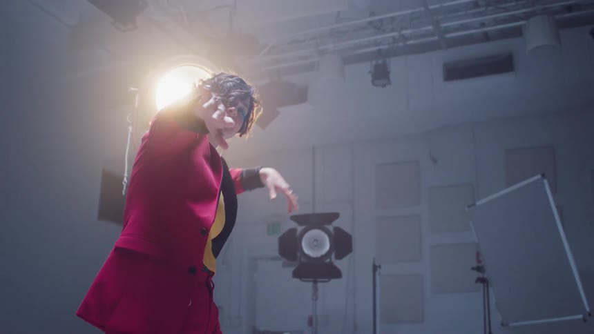 A woman is dancing by the lighting