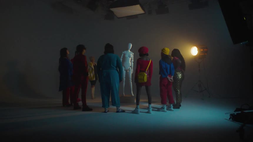 Teenagers stand around a mannequin