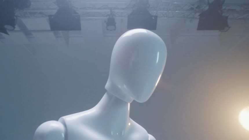 A dummy sits under the stage lights