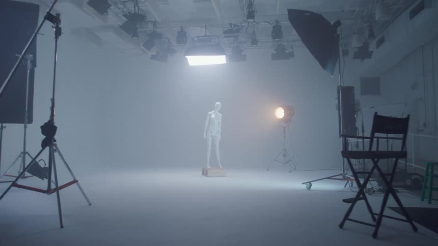 The mannequin is standing on the stage under the lights